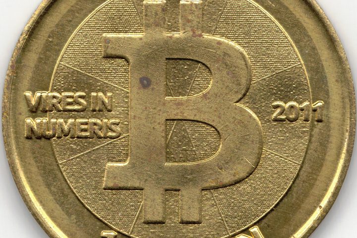 The face of a brass Casascius physical bitcoin token dated 2011