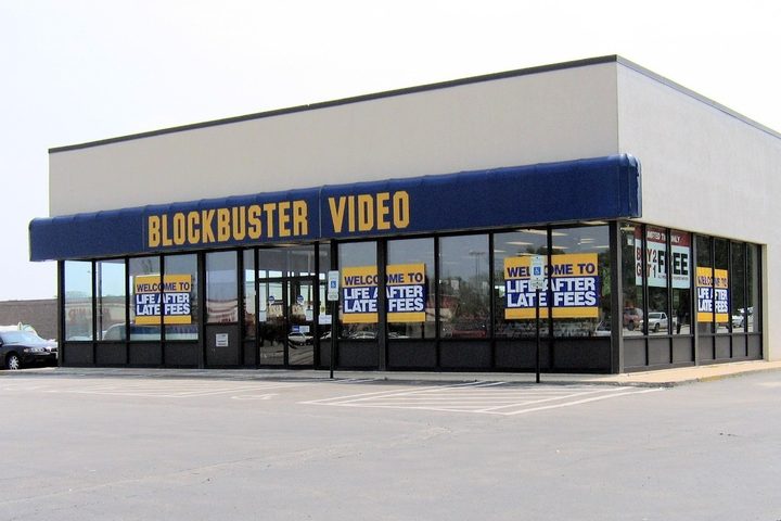 A Blockbuster Video store seen from its car park, blue and yellow signage above the windows