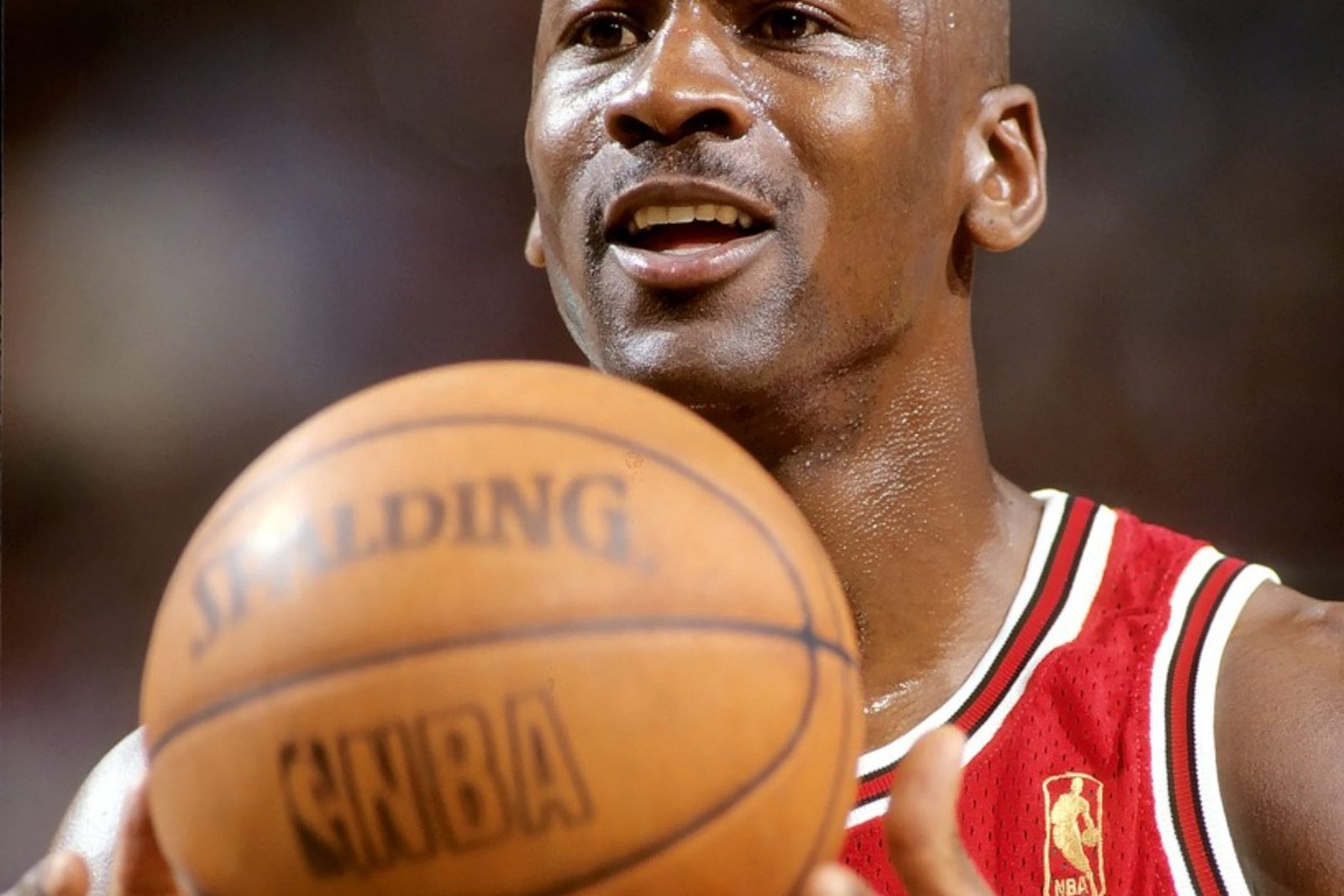 Michael Jordan in a Chicago Bulls jersey holding a basketball