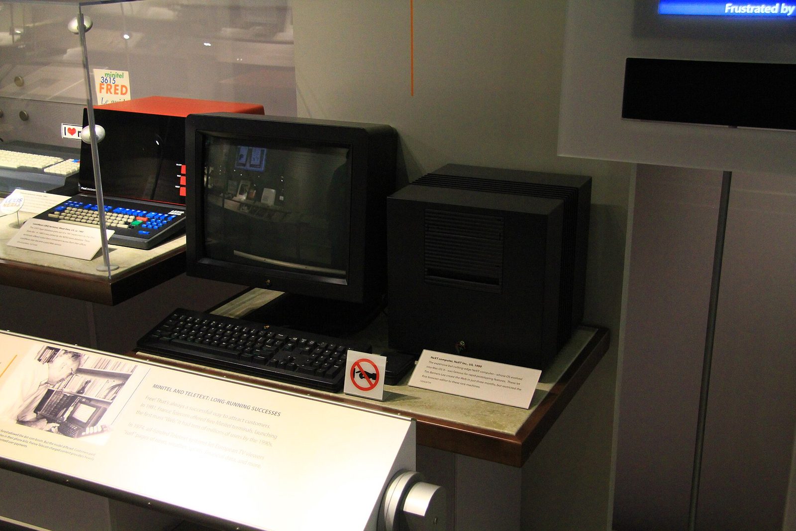 A black NeXT cube workstation with its monitor and keyboard in a museum display