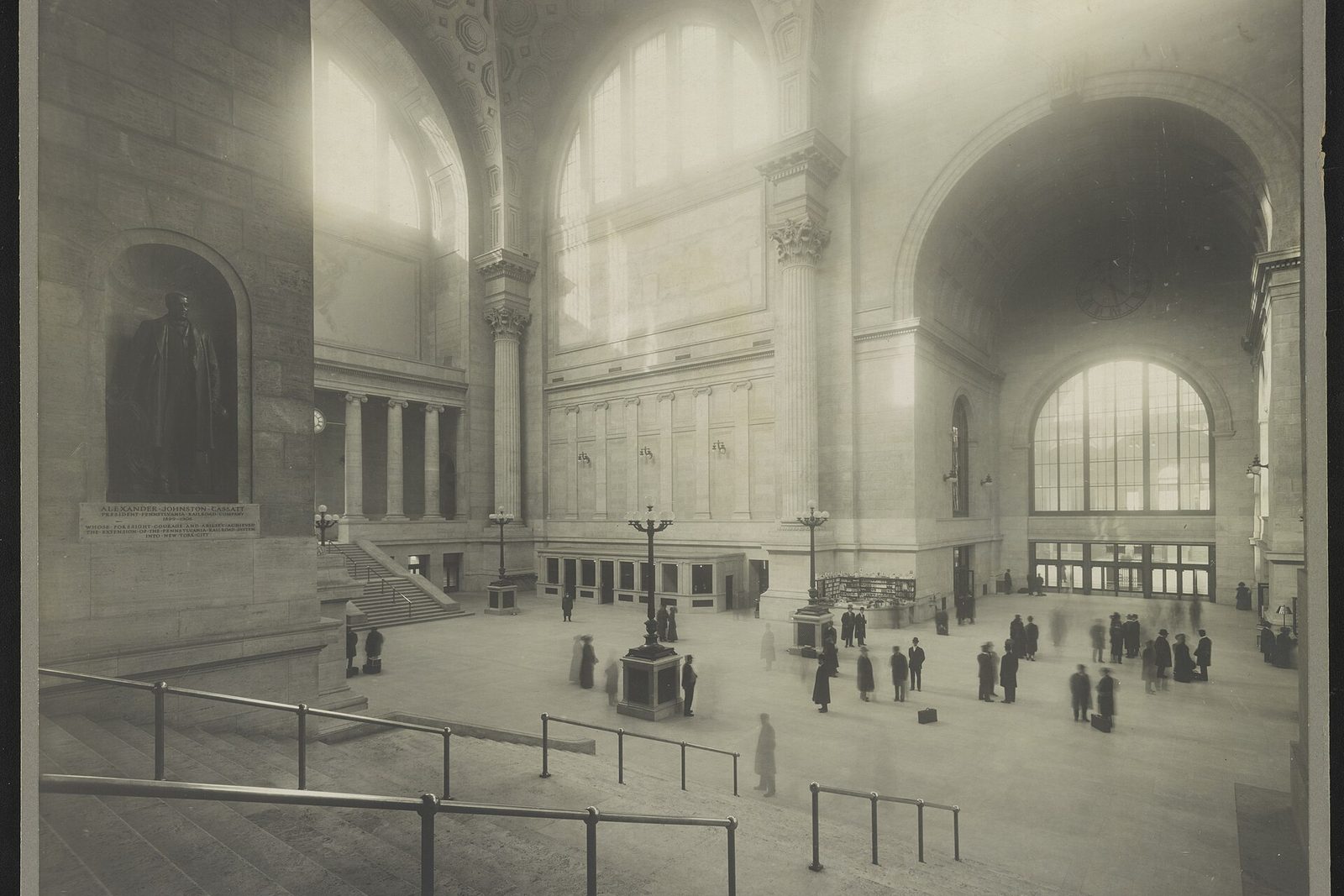 Passengers crossing the vast skylit waiting room of the original Pennsylvania Station in New York